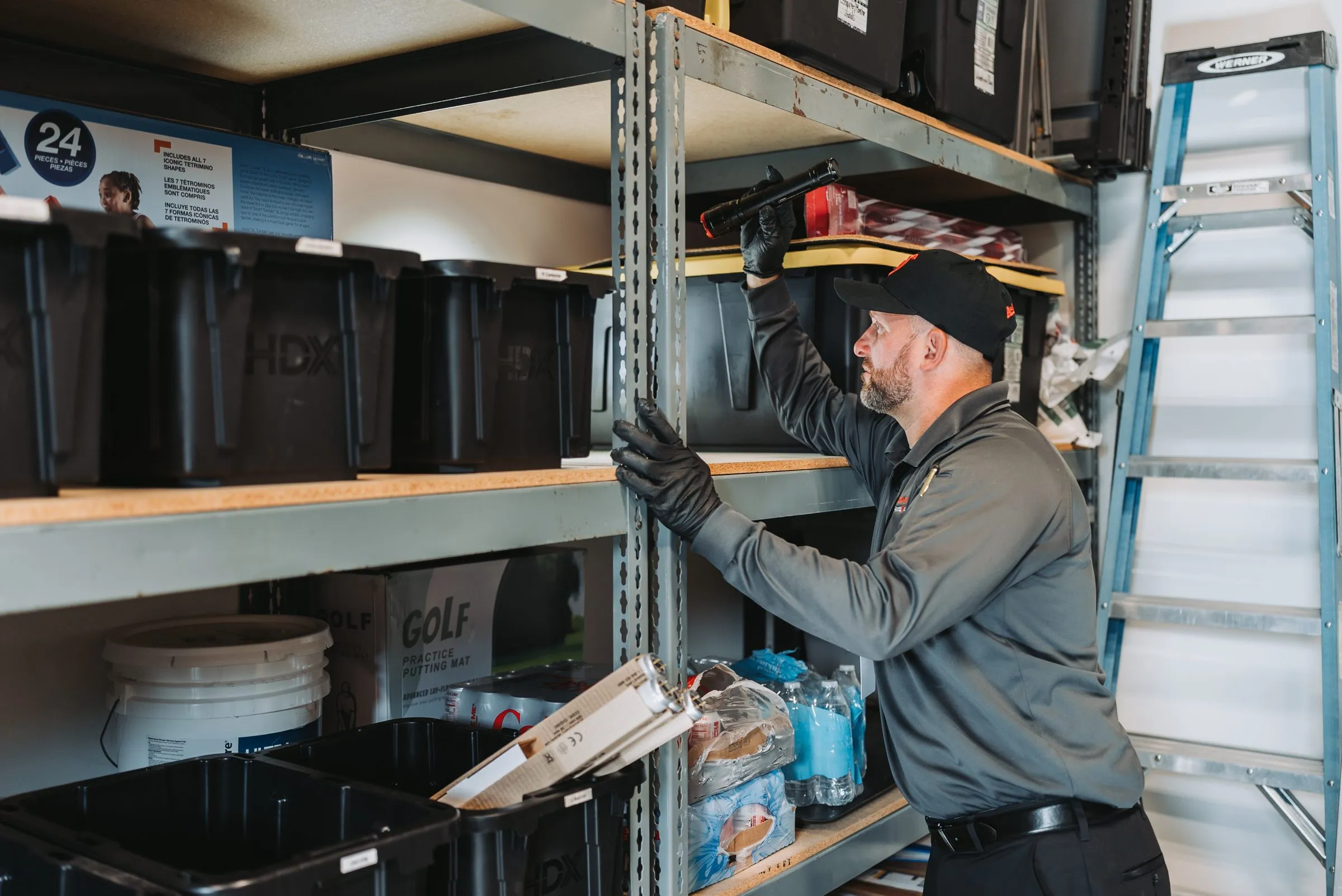 An A&A technician inspecting storage shelving at a business