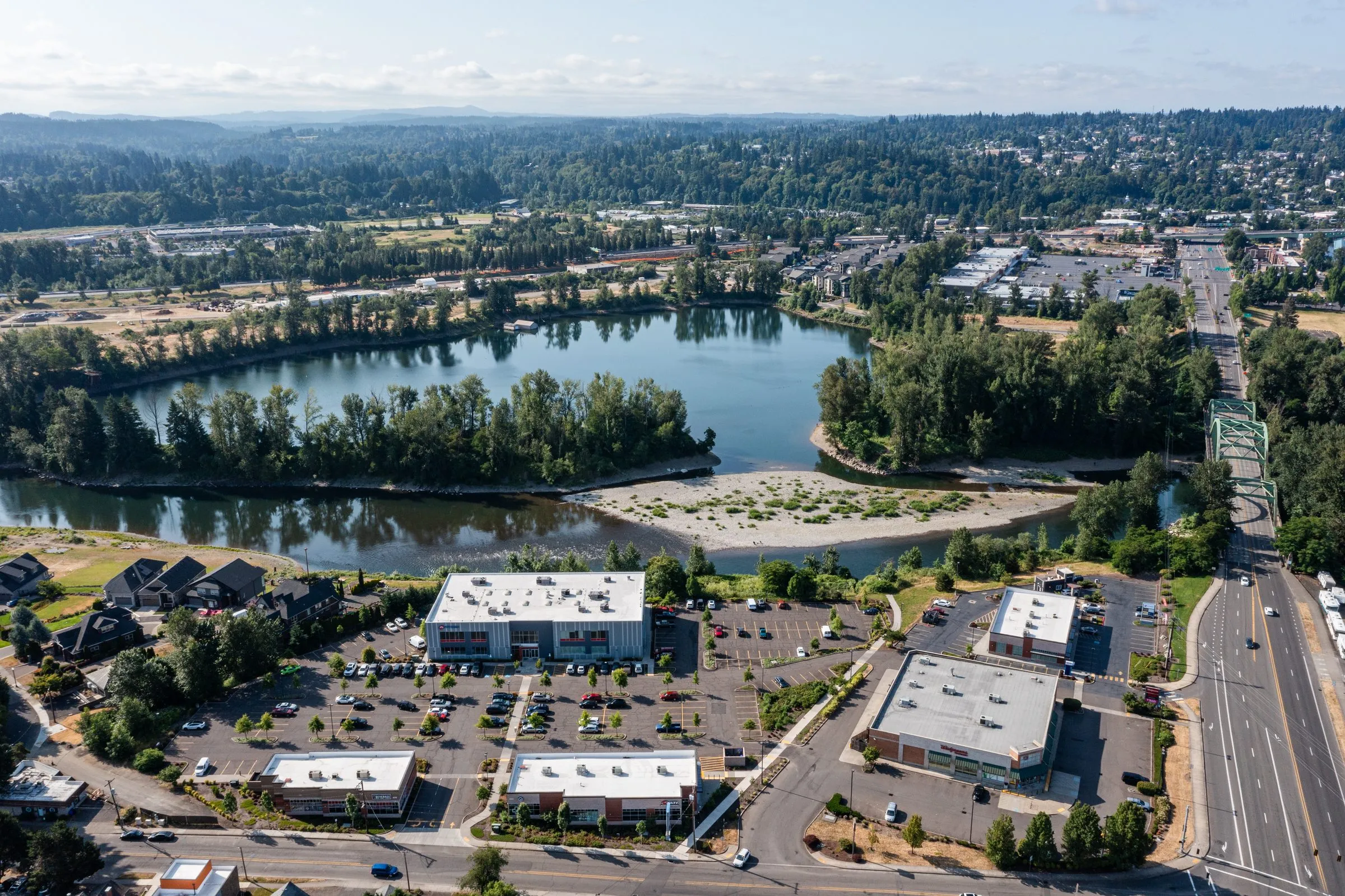 An aerial view of Clackamas, Oregon, with a lake and a shopping area