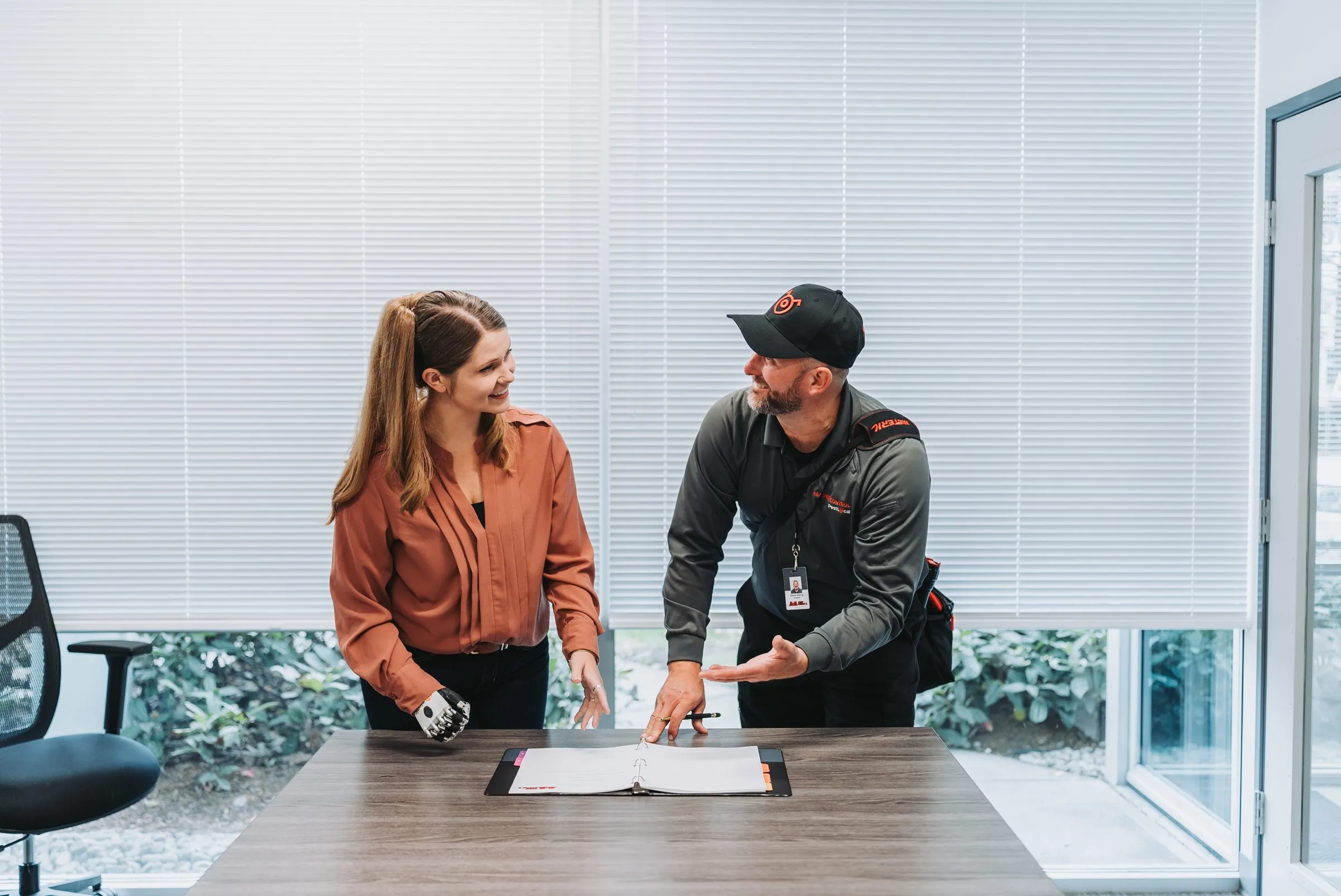 An A&A technician reviewing the service logbook with a property manager