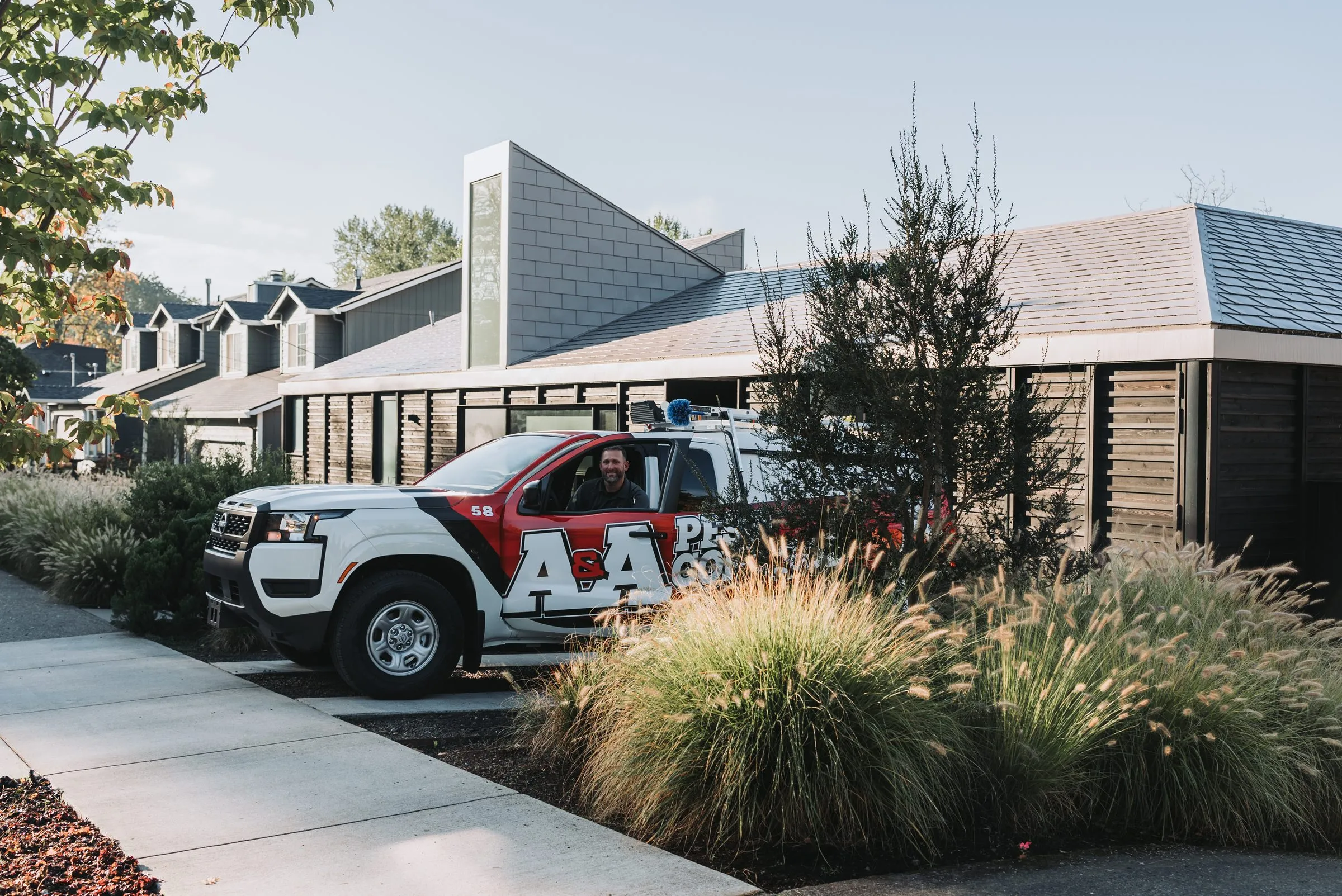 An A&A technician arriving at a customer's home in a service truck