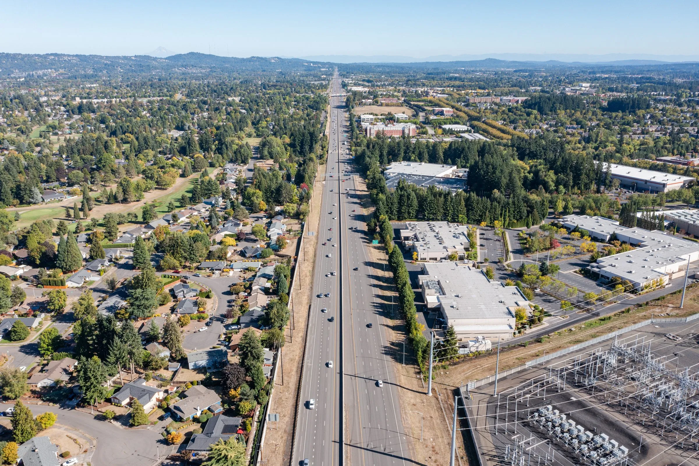 An aerial view of Hillsboro, Oregon, with a highway and neighborhoods stretching toward the hills