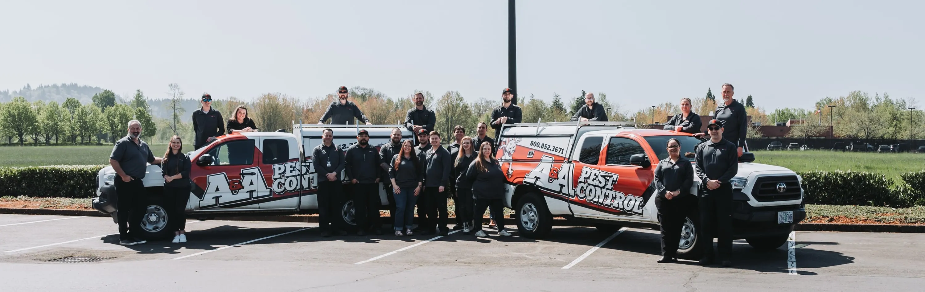 The A&A team lined up beside two A&A Pest Control trucks