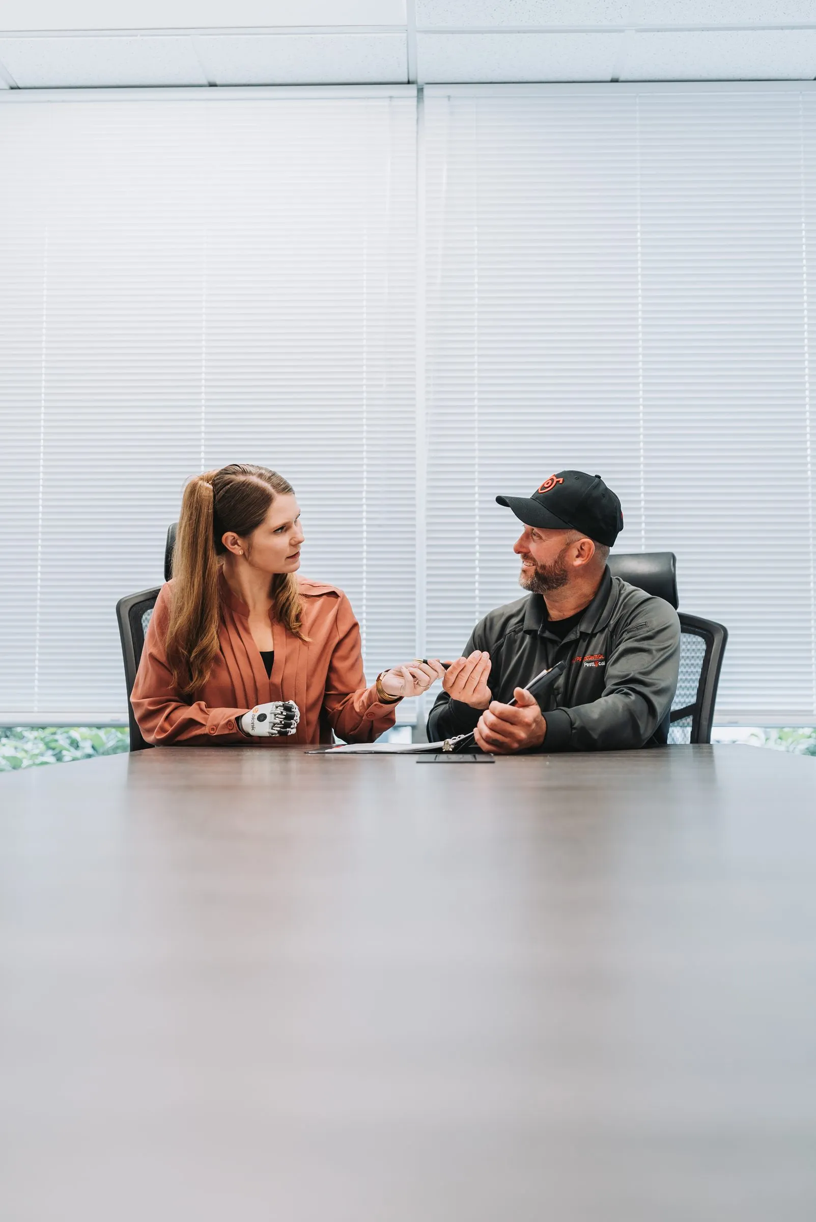 An A&A account manager meeting a client across a conference table
