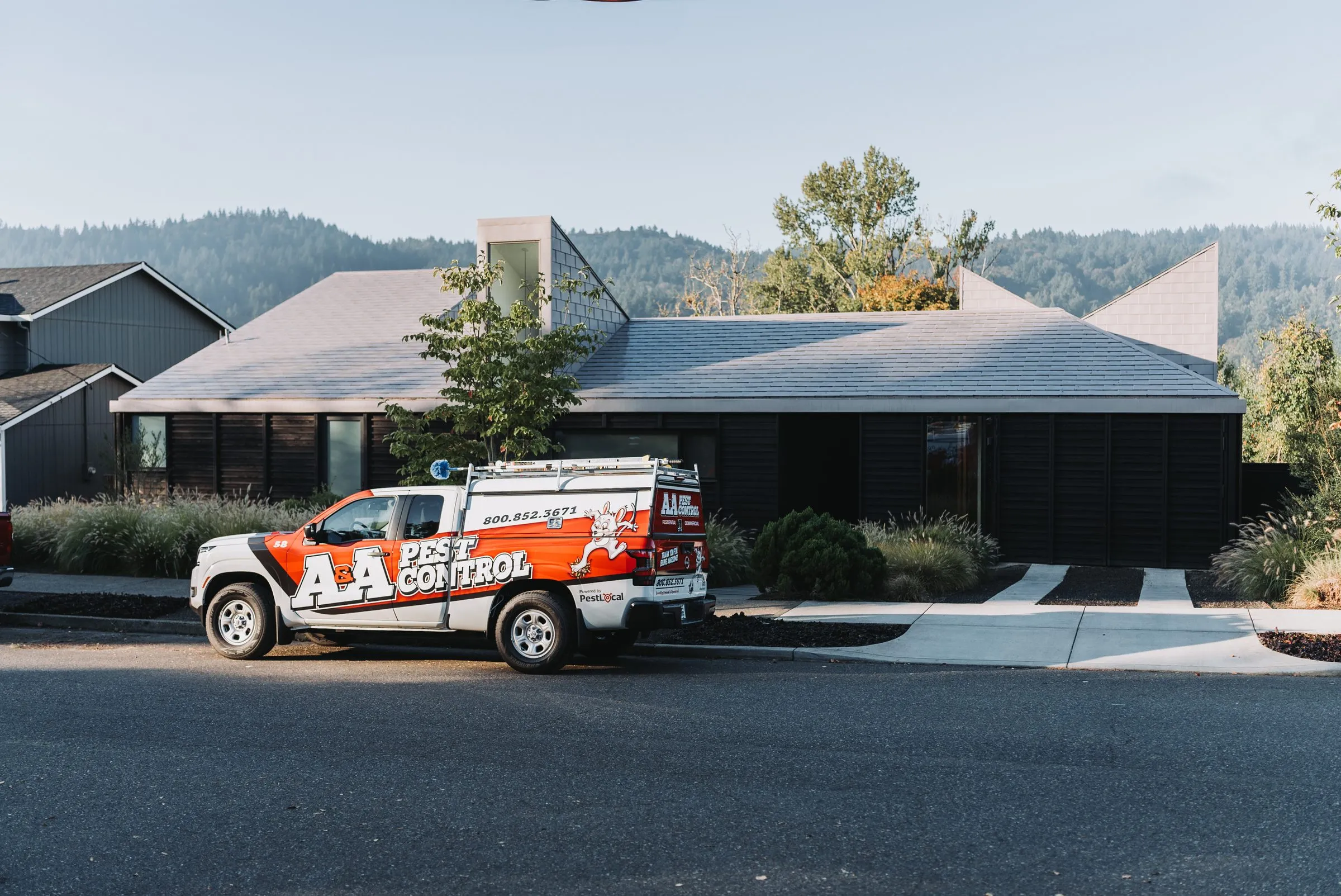 An A&A service truck parked in the driveway of a customer's home