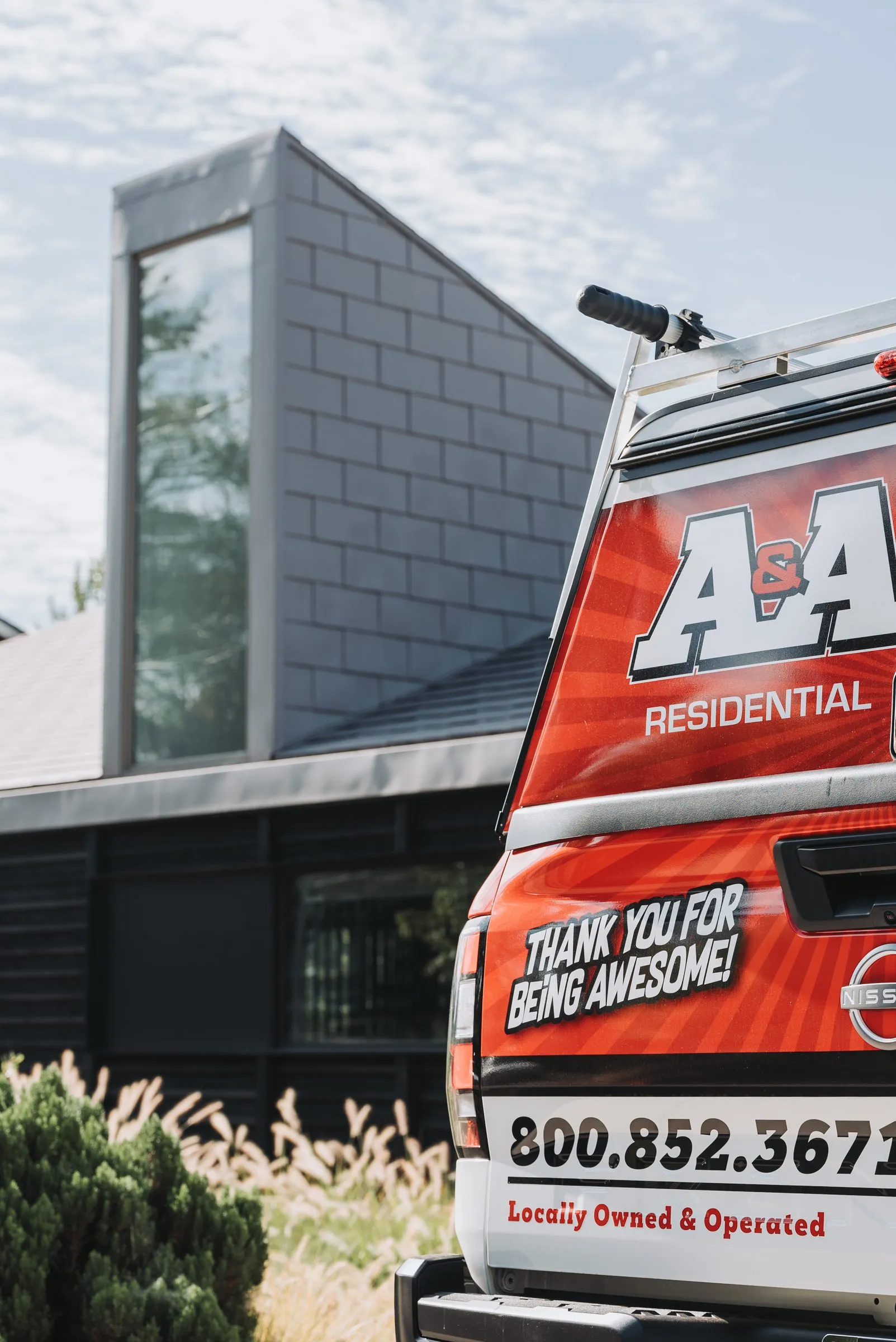 An A&A service truck parked beside a modern building