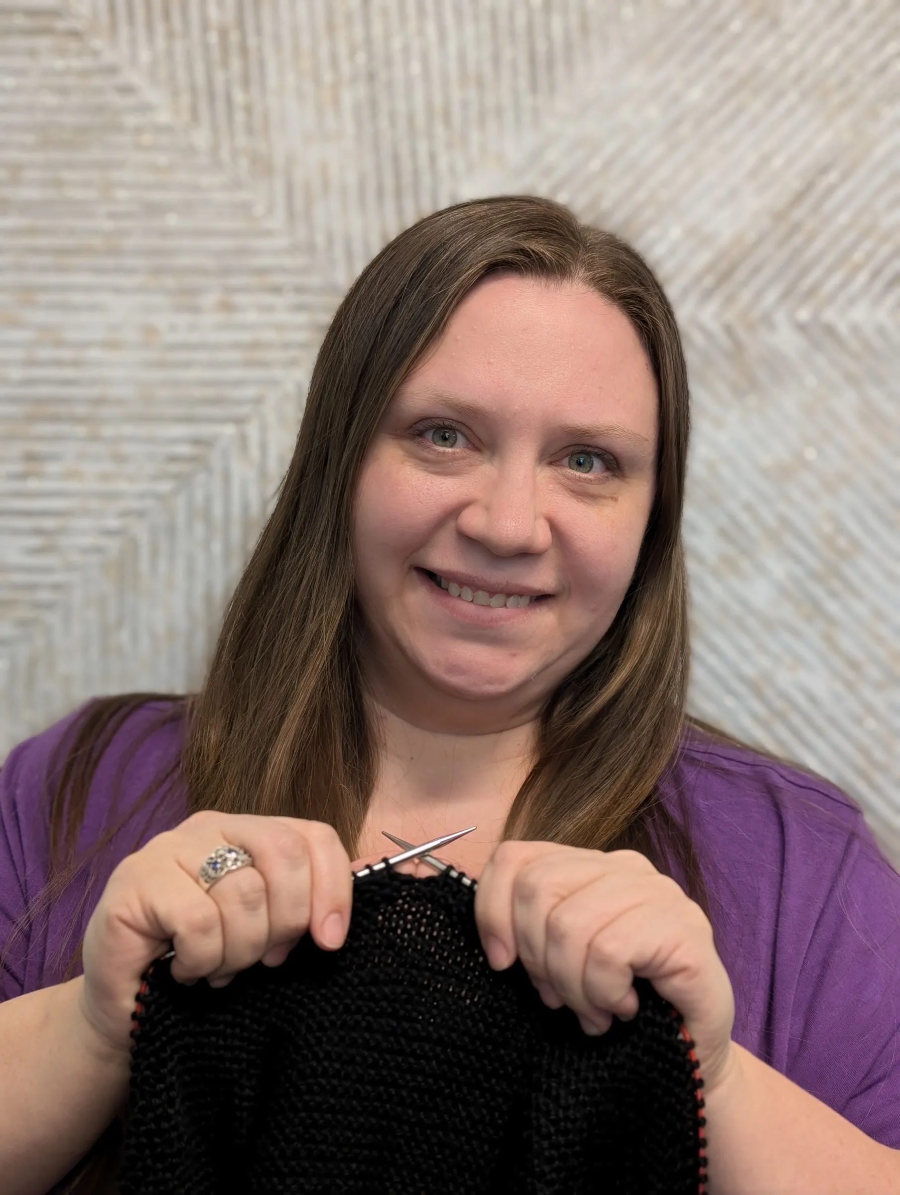 An A&A office team member smiling for a fun team portrait