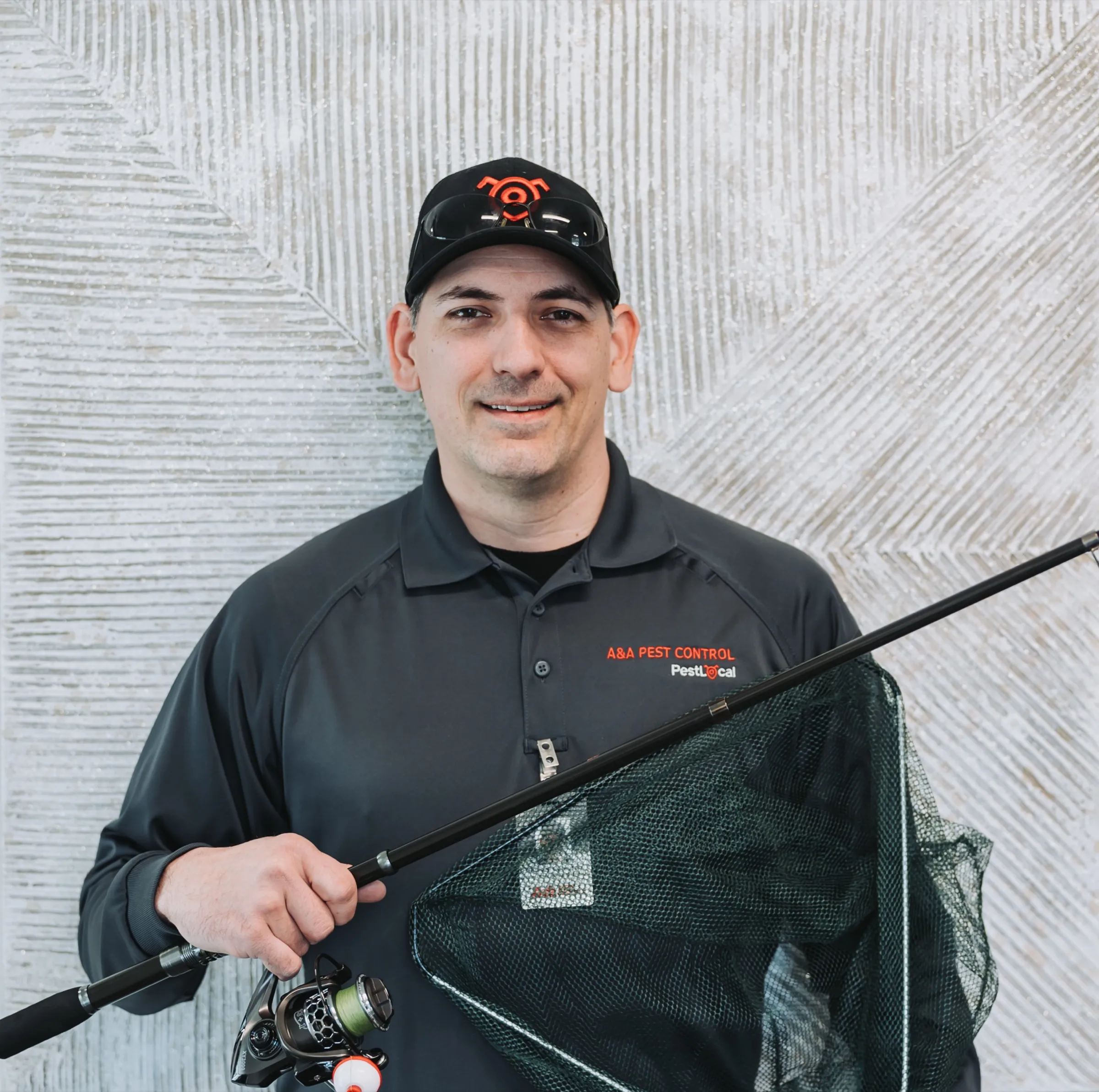 An A&A technician holding a bug net for a fun team portrait