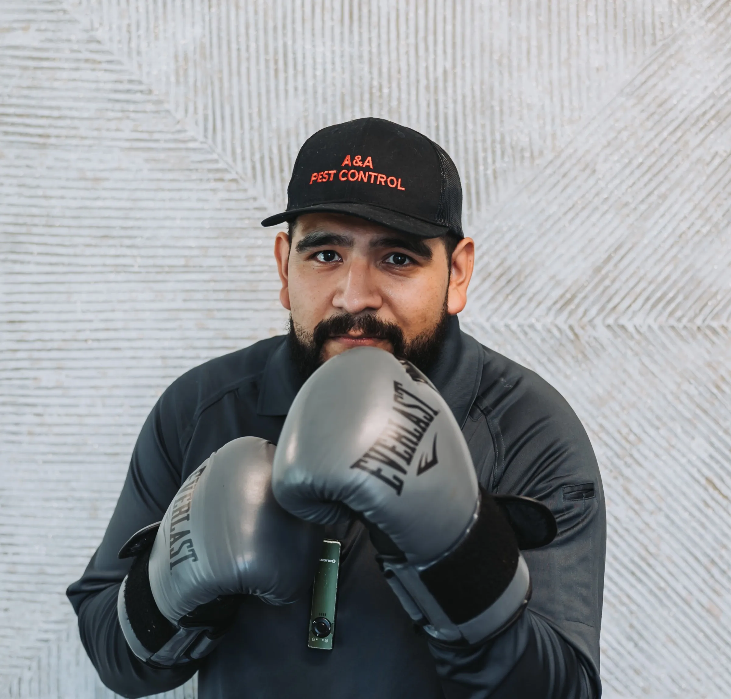 An A&A team member wearing boxing gloves for a fun team portrait