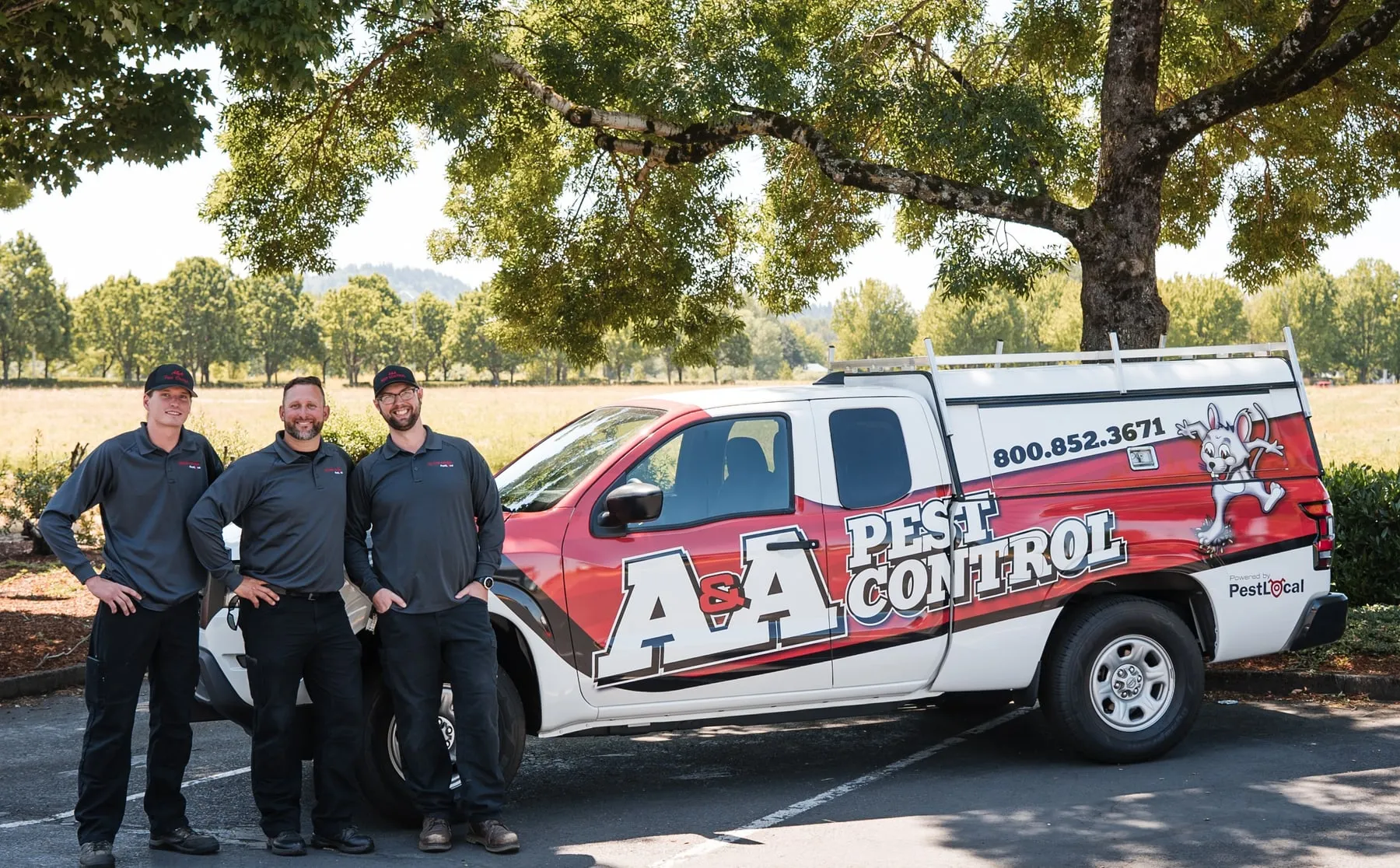 Three of A&A's Beach Boys, the coast team, standing in front of their A&A Pest Control truck