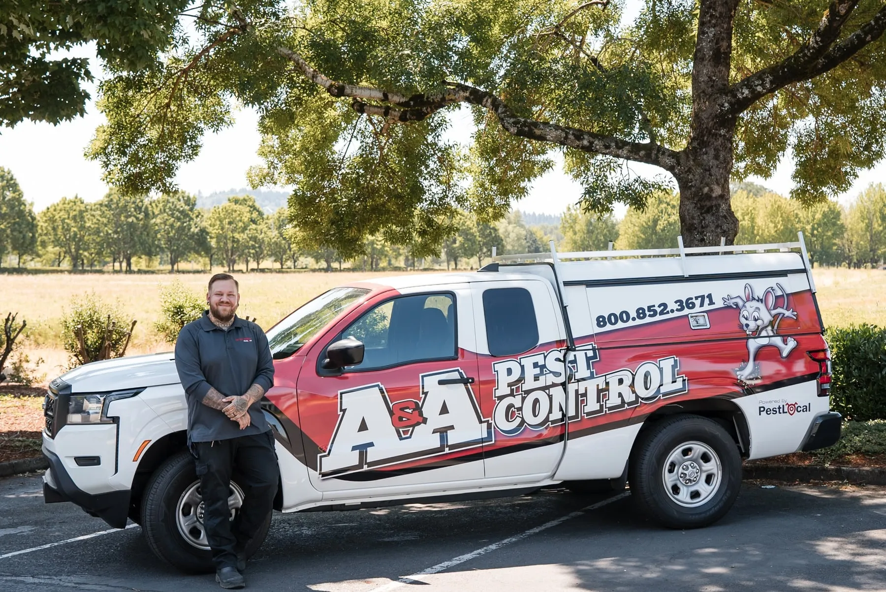John R, one of A&A's Vancouver technicians, leaning on his A&A Pest Control truck