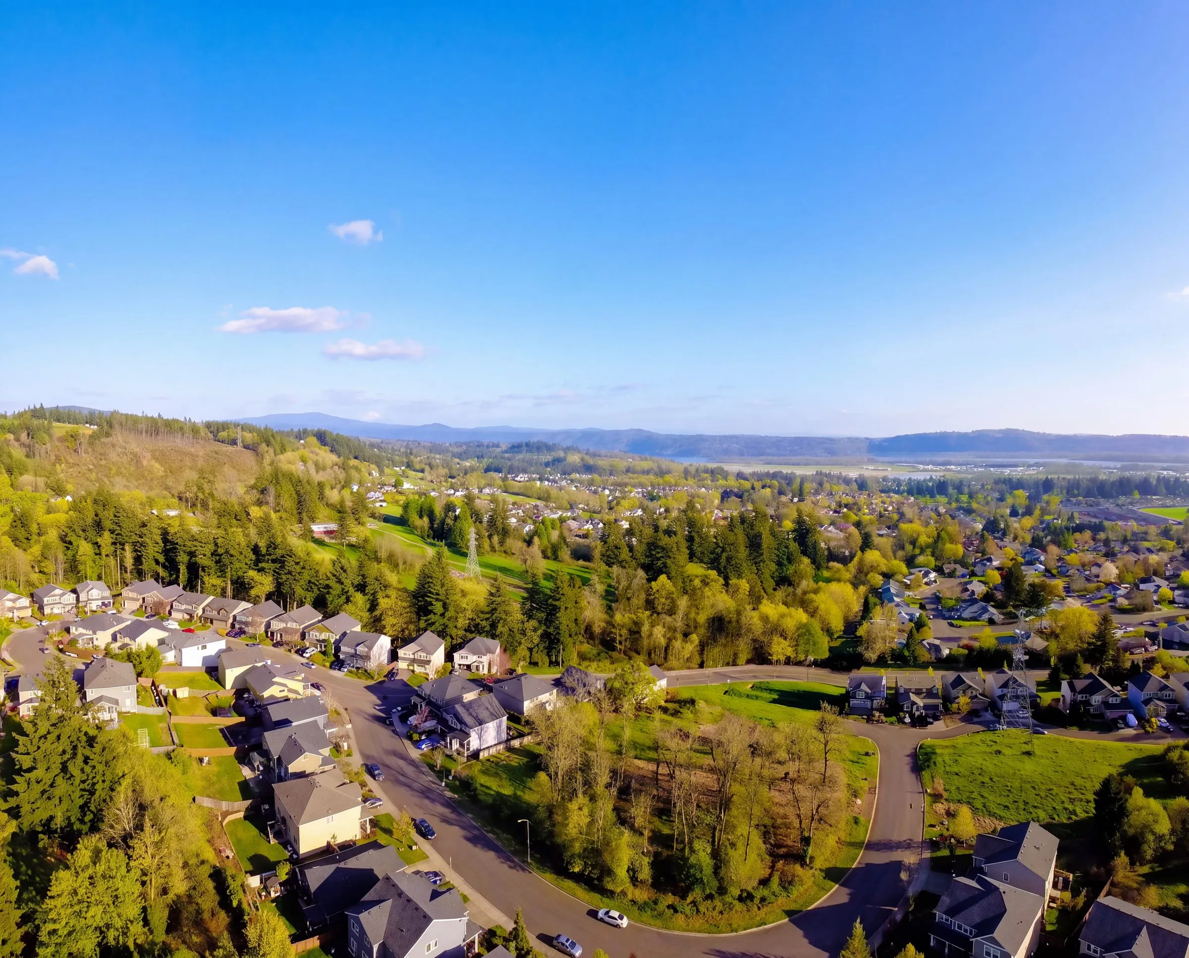 An aerial view of a neighborhood in Washougal, Washington, with green hills beyond