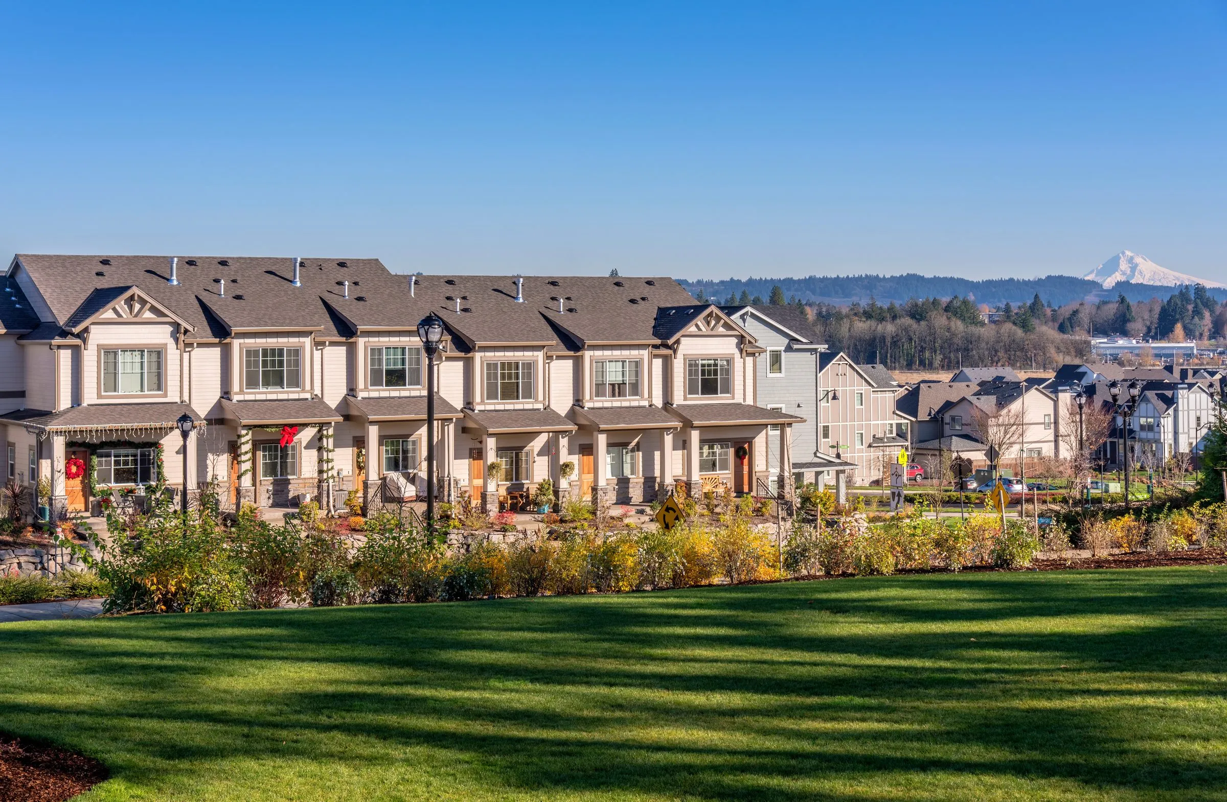 Townhomes in Wilsonville, Oregon, on a sunny day with a mountain behind them
